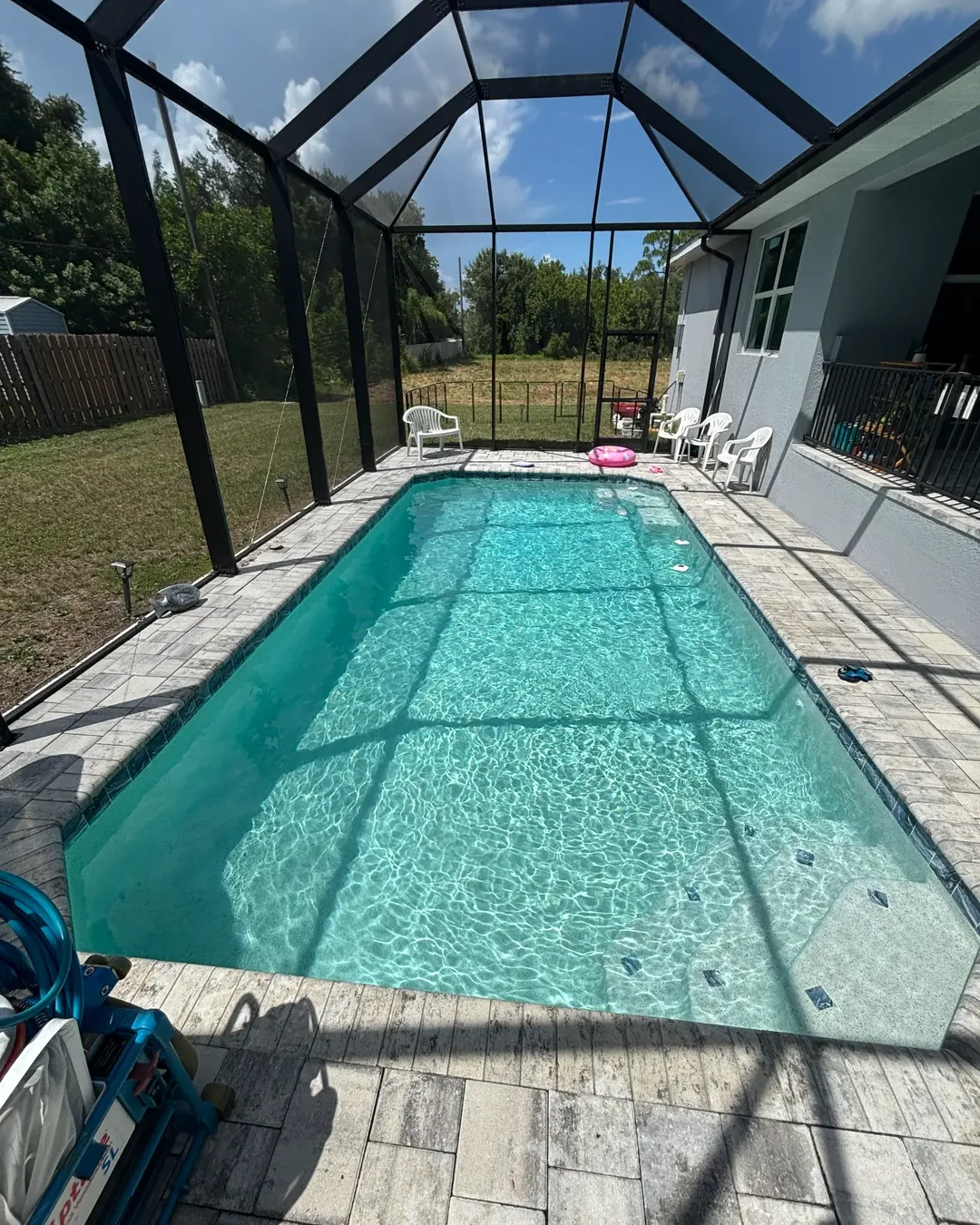 Clear rectangular screened pool with bright blue water